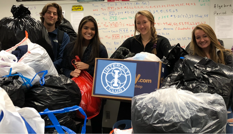 Interact co-presidents and members help transport coats